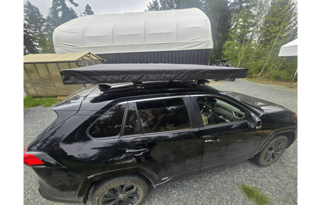 Trail Lite roof tent mounted on a vehicle, offering compact and durable camping solution for overland adventures