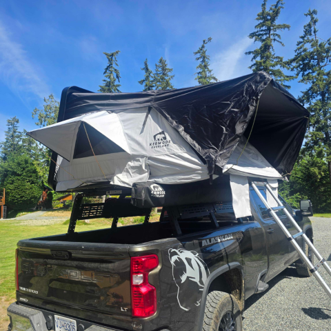 Outland XL™ ABS hard shell rooftop tent mounted on an SUV, featuring a spacious elevated sleeping platform with a durable weatherproof shell, telescopic ladder, and four-season camping design for families and overlanding adventures.