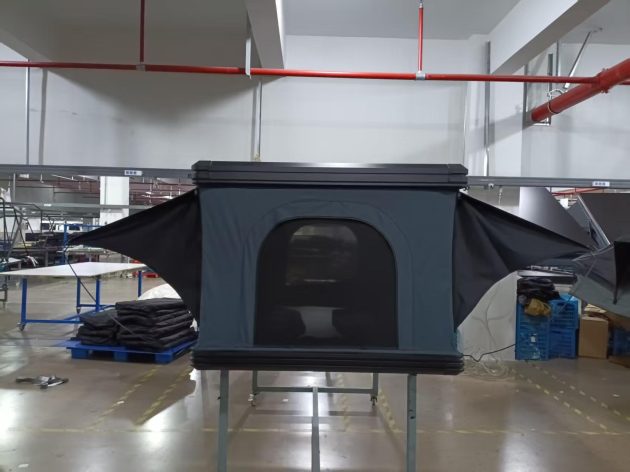 SkyRise aluminum vertical pop-up hard shell rooftop tent deployed on overland truck