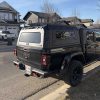 Premium aluminum gullwing truck canopy for Jeep Gladiator 2021+ in matte black, designed for overlanding, secure storage, rooftop tent mounting, and all-season Canadian conditions.