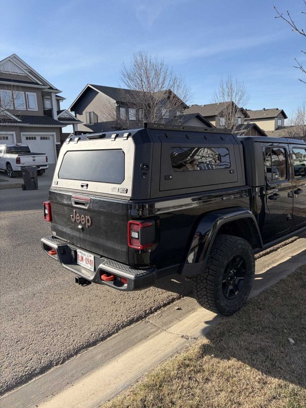 Premium aluminum gullwing truck canopy for Jeep Gladiator 2021+ in matte black, designed for overlanding, secure storage, rooftop tent mounting, and all-season Canadian conditions.