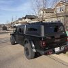 Premium aluminum gullwing truck canopy for Jeep Gladiator 2021+ in matte black, designed for overlanding, secure storage, rooftop tent mounting, and all-season Canadian conditions.