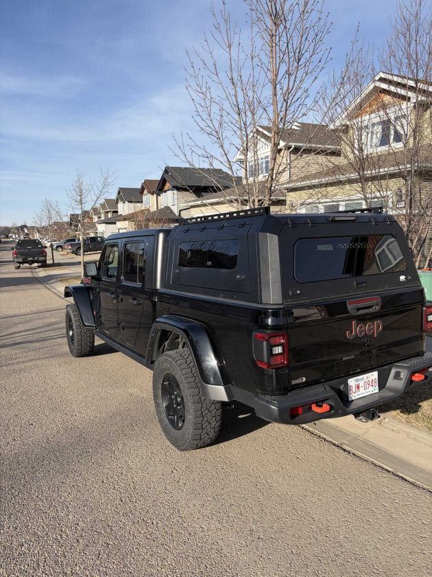 Premium aluminum gullwing truck canopy for Jeep Gladiator 2021+ in matte black, designed for overlanding, secure storage, rooftop tent mounting, and all-season Canadian conditions.