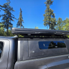 Toyota Tacoma 2016–2023 truck canopy mounted on bed with sleek black finish, ideal for secure storage and overlanding adventures
