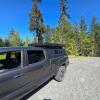 Toyota Tacoma 2016–2023 truck canopy mounted on bed with sleek black finish, ideal for secure storage and overlanding adventures