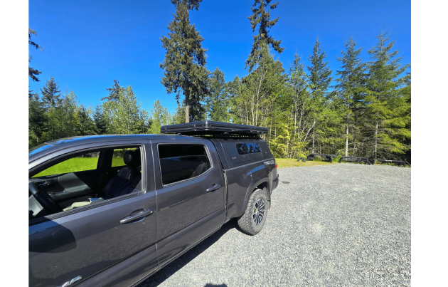 Toyota Tacoma 2016–2023 truck canopy mounted on bed with sleek black finish, ideal for secure storage and overlanding adventures