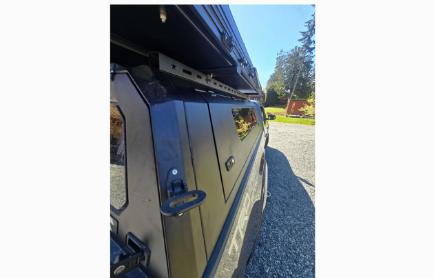 Toyota Tacoma 2016–2023 truck canopy mounted on bed with sleek black finish, ideal for secure storage and overlanding adventures