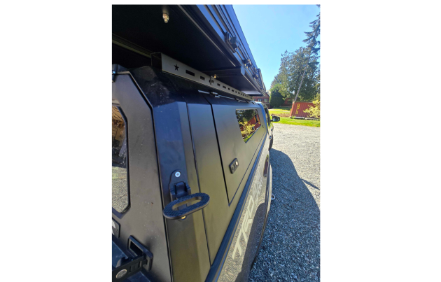 Toyota Tacoma 2016–2023 truck canopy mounted on bed with sleek black finish, ideal for secure storage and overlanding adventures